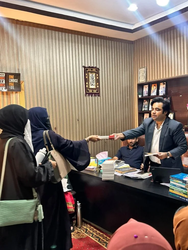 ICEP Classroom Faculty distributing study material to students at ICEP